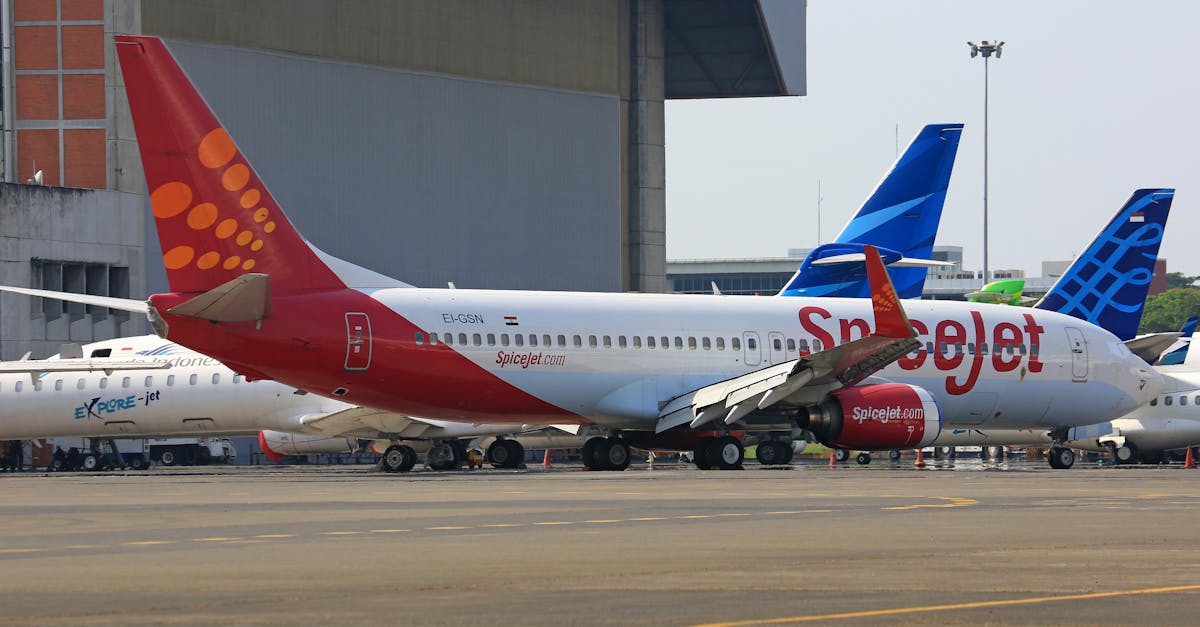 SpiceJet aircraft parked at the runway with other planes in the background, perfect for travel themes.