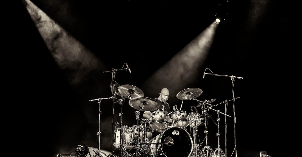 Dynamic concert scene with a drummer rocking on stage under spotlights in San Salvador.